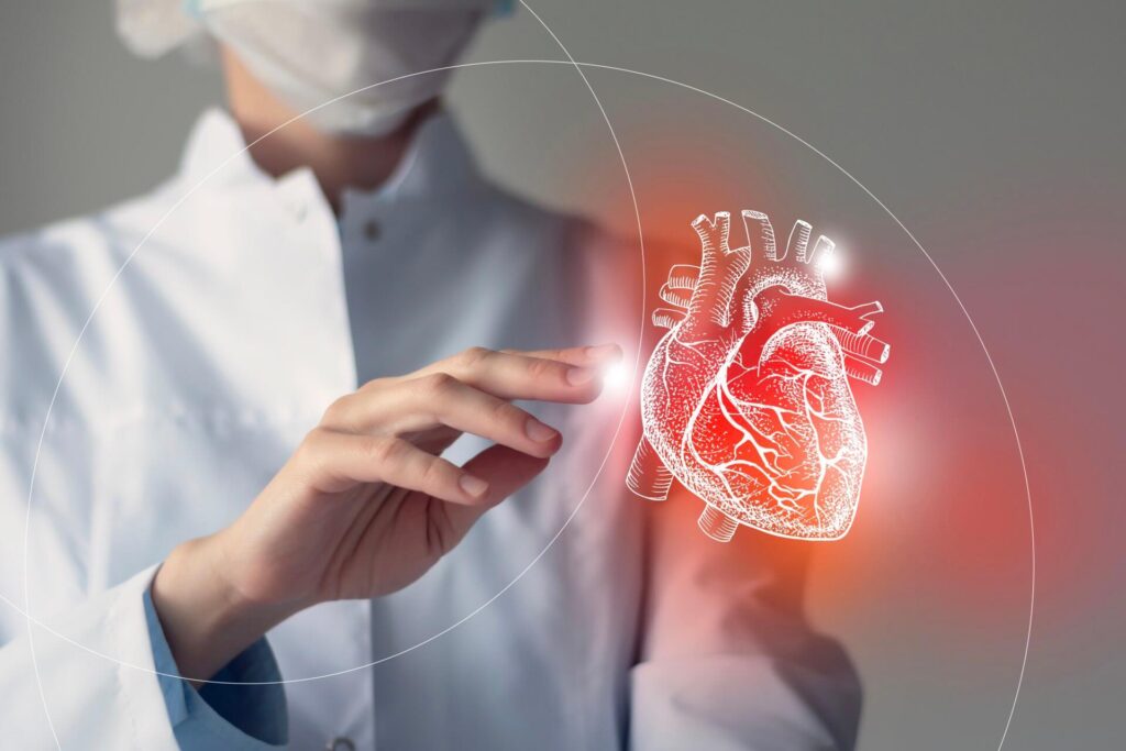 A medical professional in a lab coat and face mask, with a holographic image of a heart in front of them, symbolizing the advanced treatment approaches for heart failure as recommended by the European Society of Cardiology.